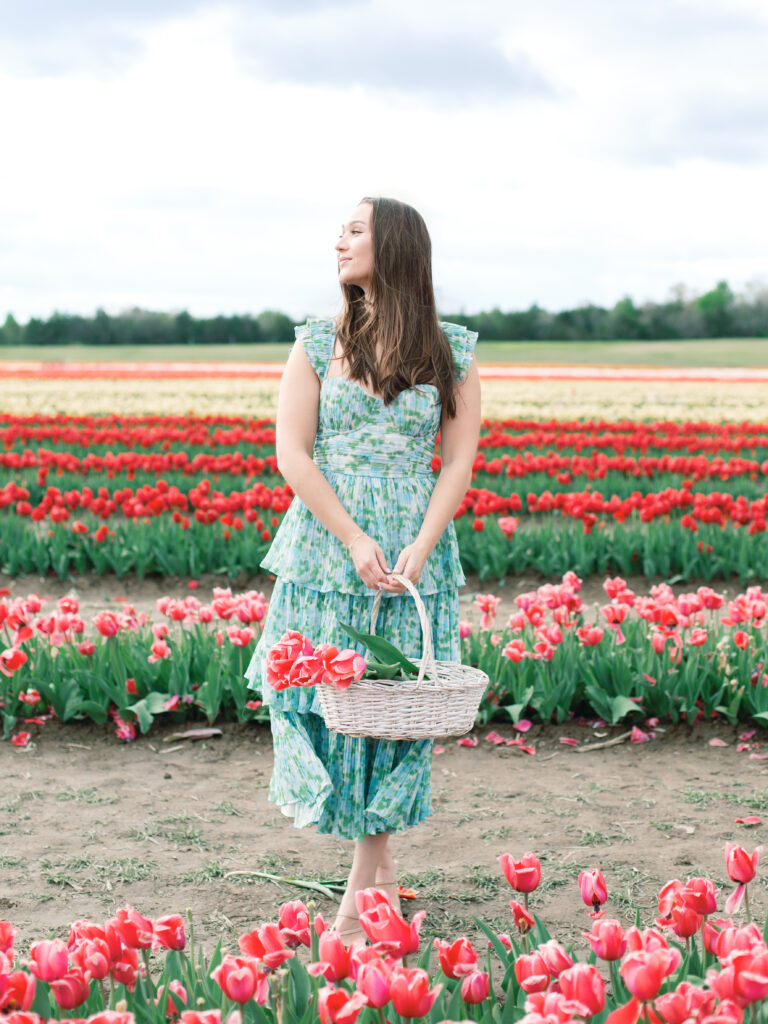 Anne & Elijah walking in the tulip fields in full Bloom at Burnside Farms